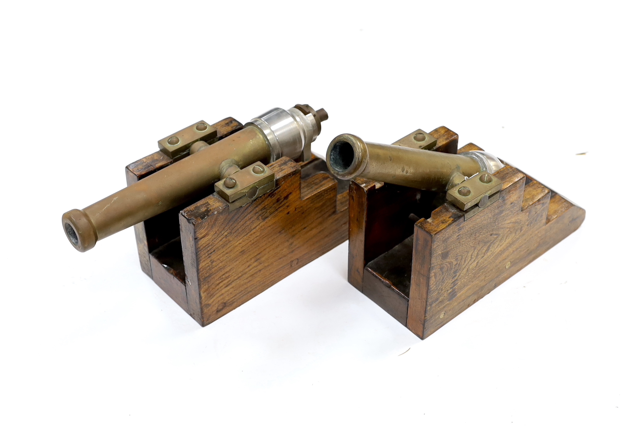 A near pair of breech loading brass and steel starting cannons, on elm stands, longest barrel 24.5cm